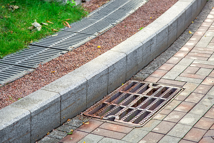 an exterior french drain on sidewalk